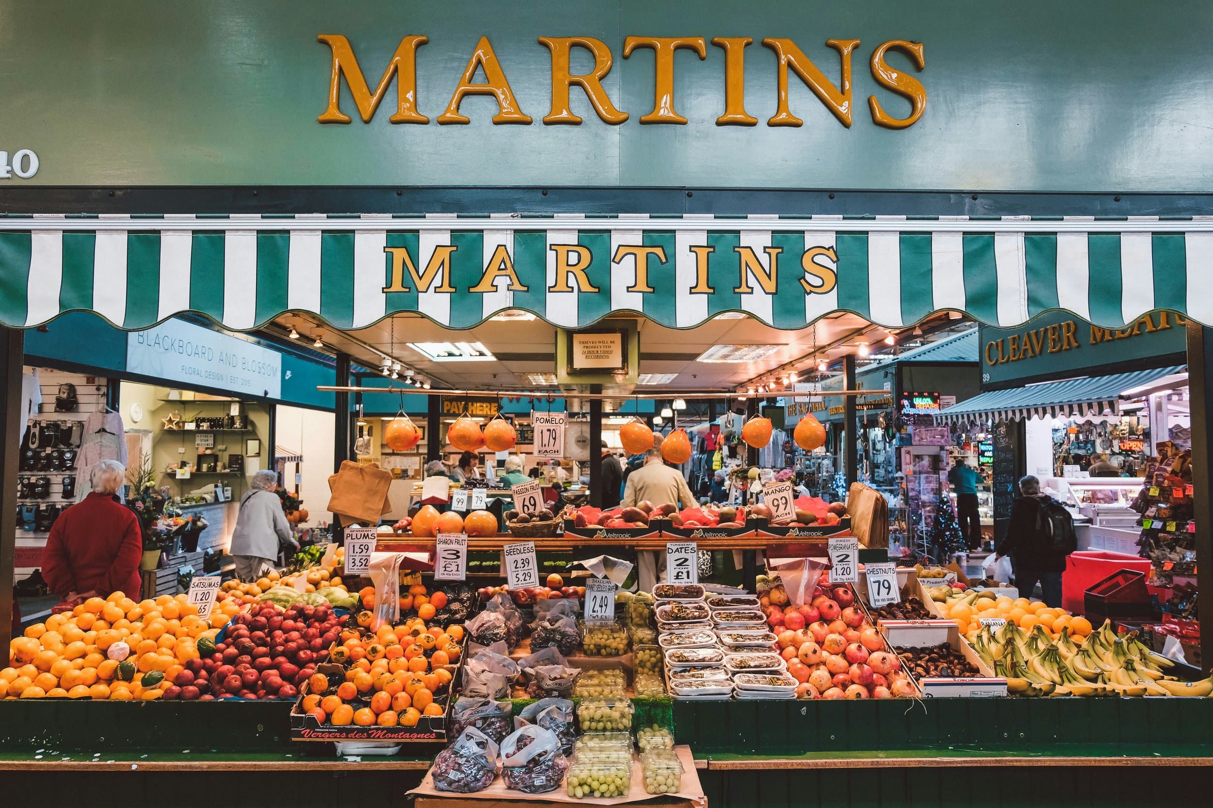 Martins fruit and vegetable stall, with its green striped awning and gold lettering.